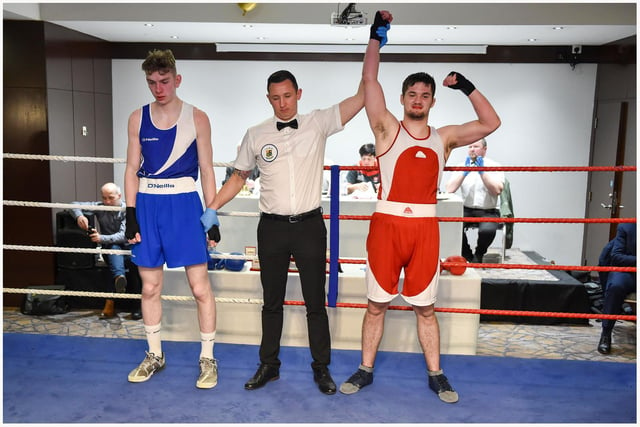 Brad Mc Sceveeny from Scorpion, Ballymoney club, takes the decision over Gavin Rainey Loup in this 75kg contest.