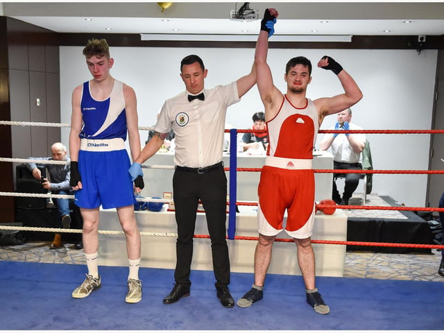 Brad Mc Sceveeny from Scorpion, Ballymoney club, takes the decision over Gavin Rainey Loup in this 75kg contest.