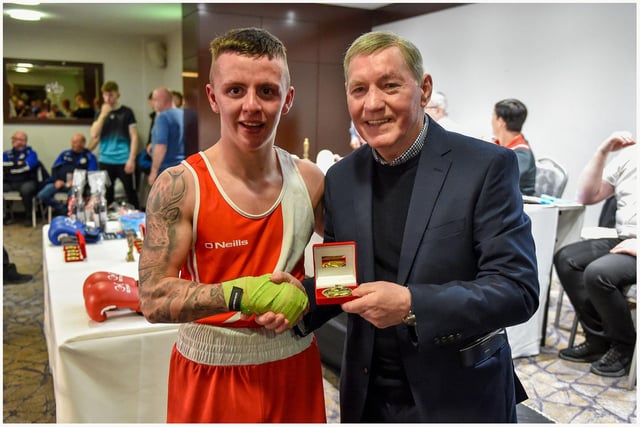 Tiarrnan Glenon St Joseph's is congratulated by former European lightweight champion Charlie Nash who was guest of the Co. Derry Boxing Board.
