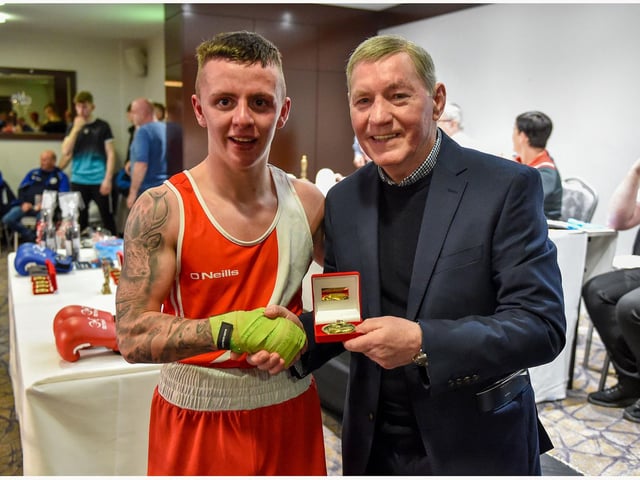 Tiarrnan Glenon St Joseph's is congratulated by former European lightweight champion Charlie Nash who was guest of the Co. Derry Boxing Board.