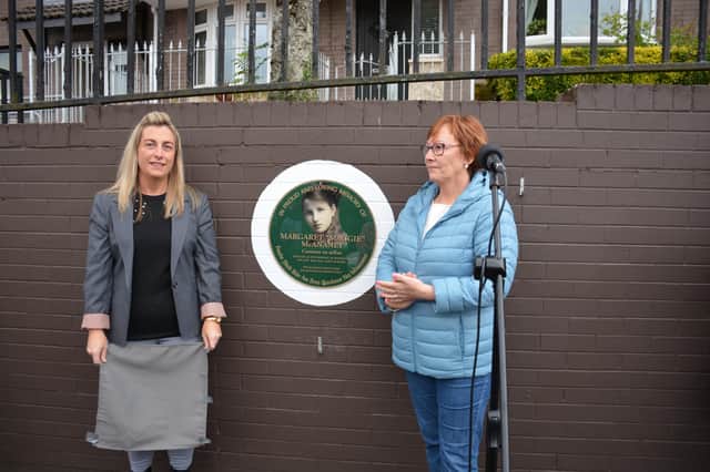 Philomena McLaughlin, sister of Volunteer Ethel Lynch, and Brid Kelly unveil the 100th Anniversary plaque.