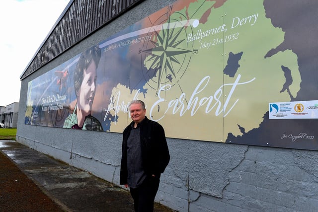 Pictured at the unveiling of a mural commemorating the 90th Anniversary of the landing of Amelia Earhart in Derry on the gable wall of the Galliagh Co-Op on Friday afternoon last is creater of the artwork Derry artist Joseph Campbell.  The digital print created from Joseph’s original artwork spans 48ft wide and 8ft high.  Photo: George Sweeney.  DER2220GS – 066