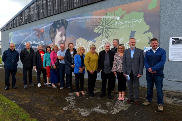 Group pictured at the unveiling of a mural commemorating the 90th Anniversary of the landing of Amelia Earhart in Derry on the gable wall of the Galliagh Spar (Co-Op) on Friday afternoon last. Included in the photograph are Ollie Green, Colr Maeve O’Neill, Mary Casey, Angela Askin, DSDC, Ciara Ferguson MLA, Colr Angela Dobbins, artist Joseph Campbell, Colr Sandra Duffy, Cathal Crumley, CRJ and Colr Conor Heaney.  Photo: George Sweeney.  DER2220GS – 065