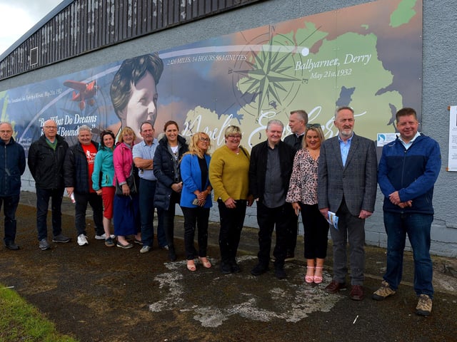 Group pictured at the unveiling of a mural commemorating the 90th Anniversary of the landing of Amelia Earhart in Derry on the gable wall of the Galliagh Spar (Co-Op) on Friday afternoon last. Included in the photograph are Ollie Green, Colr Maeve O’Neill, Mary Casey, Angela Askin, DSDC, Ciara Ferguson MLA, Colr Angela Dobbins, artist Joseph Campbell, Colr Sandra Duffy, Cathal Crumley, CRJ and Colr Conor Heaney. Photo: George Sweeney. DER2220GS – 065