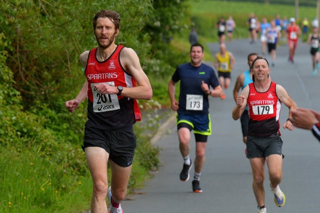 City of Derry Spartans’ Stephen Jamison (201) and Diarmuid O’Kane run along Lower Main Street during the Furey Insurance Buncrana 5Km on Wednesday evening last. Photo: George Sweeney.  DER2222GS – 053