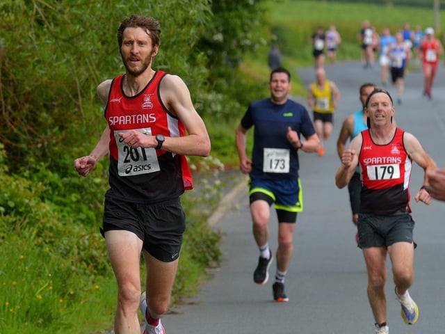City of Derry Spartans’ Stephen Jamison (201) and Diarmuid O’Kane run along Lower Main Street during the Furey Insurance Buncrana 5Km on Wednesday evening last. Photo: George Sweeney. DER2222GS – 053