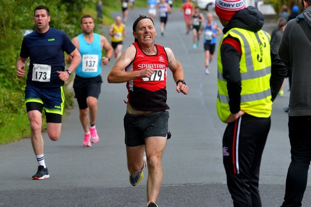 City of Derry Spartans’ Diarmuid O’Kane at the finish line of the Furey Insurance Buncrana 5Km, on Lower Main Street, on Wednesday evening last. Photo: George Sweeney.  DER2222GS – 054