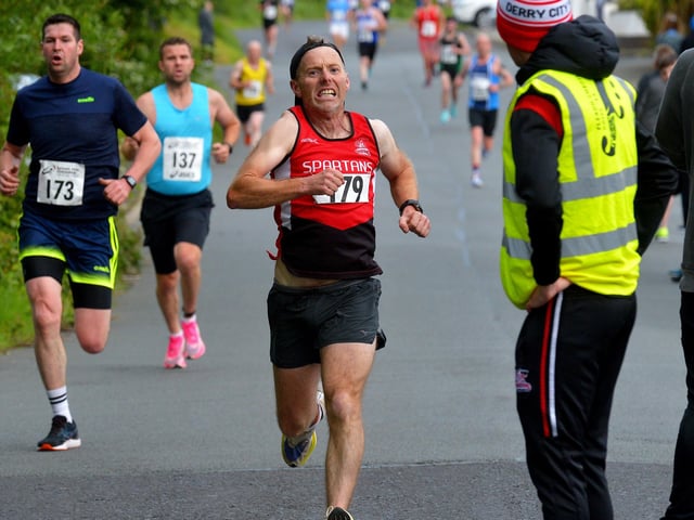 City of Derry Spartans’ Diarmuid O’Kane at the finish line of the Furey Insurance Buncrana 5Km, on Lower Main Street, on Wednesday evening last. Photo: George Sweeney.  DER2222GS – 054