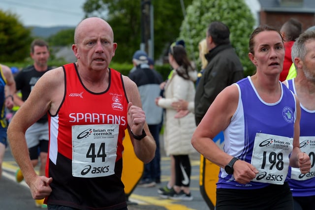 City of Derry Spartans’ Gary Crossan and Foyle Valley’s Dolores McLaughlin compete in the Furey Insurance Buncrana 5Km on Wednesday evening last. Photo: George Sweeney.  DER2222GS – 043