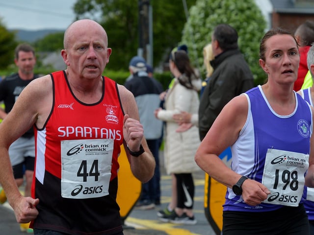 City of Derry Spartans’ Gary Crossan and Foyle Valley’s Dolores McLaughlin compete in the Furey Insurance Buncrana 5Km on Wednesday evening last. Photo: George Sweeney. DER2222GS – 043