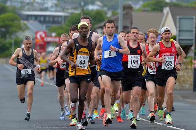 Eskander Turki (64) Annadale Striders, who finished second, race winner John Paul Williamson (8) unattached and City of Derry Spartans’ Kyle Doherty (232), who finished fifth, lead the pack along Railway Road during the Furey Insurance Buncrana 5Km on Wednesday evening last. Photo: George Sweeney.  DER2222GS – 041