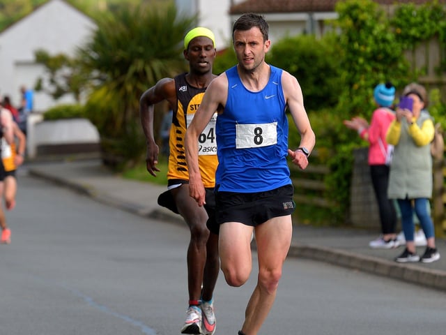 Furey Insurance Buncrana 5Km Road Race winner, unattached runner, John Paul Williamson(8) and second placed Eskander Turki, Annadale Striders, near the finish line in Lower Main Street on Wednesday evening last. Photo: George Sweeney. DER2222GS – 047