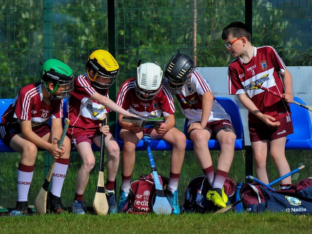 Ballinascreen hurlers check up on the opposition in the match programme at Páirc Na Magha during the Seán Mellon Hurling Festival. Photo: George Sweeney. DER2223GS – 134