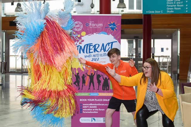Mascot Shannon Peake jumps in the air with Ronan Tester, joint chair and Mags Anderson, Education & Schools Marketing Officer at the Millennium Forum pictured at the launch of the INTERACT Youth Arts Festival 2022 in the Millennium Forum. Picture Martin McKeown. 07.06.22