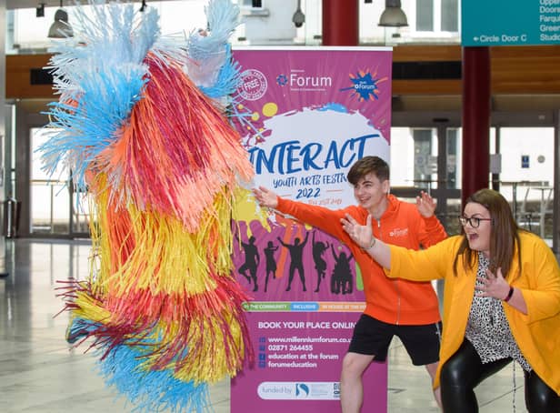 Mascot Shannon Peake jumps in the air with Ronan Tester, joint chair and Mags Anderson, Education & Schools Marketing Officer at the Millennium Forum pictured at the launch of the INTERACT Youth Arts Festival 2022 in the Millennium Forum. Picture Martin McKeown. 07.06.22
