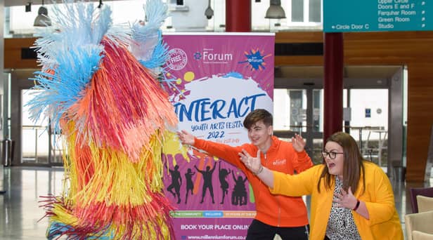 Mascot Shannon Peake jumps in the air with Ronan Tester, joint chair and Mags Anderson, Education & Schools Marketing Officer at the Millennium Forum pictured at the launch of the INTERACT Youth Arts Festival 2022 in the Millennium Forum. Picture Martin McKeown. 07.06.22