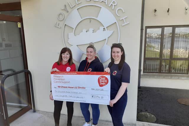 Mona Duddy, NICHS Care Services Co-ordinator receiving a cheque from Rachel Dobbins and Danielle Francis from Foyle Search and Rescue.