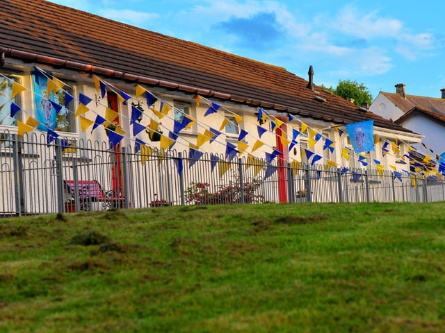 Bungalows in The Wells draped in buntings, the colours of the Ukrainian flag, during ‘An Turas – The Journey’ celebratory pageant on the life and legacy of Saint Colmcille held in the Bogside, on Thursday evening last. Photograph: George Sweeney. DER2224GS – 038