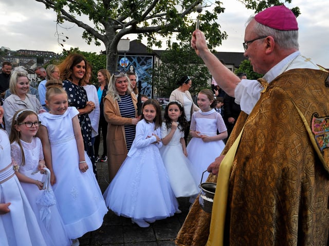 Children who recently made their First Communion blessed by The Most Reverend Dr Donal McKeown, Bishop of Derry, during the traditional Saint Colmcille Feast Day Blessing at St Columba’s Well in the Bogside, on Thursday evening last. Photograph: George Sweeney. DER2224GS – 035