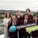 Pictured (l-r) are teacher Nicole Sloane, students Ellie Rankin, Andrew Logan, Anas Mohammad, James Daniell, and Farrah Foster with Scott Howes from Keep Northern Ireland Beautiful and Minister Poots.