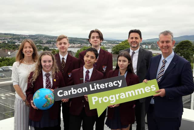 Pictured (l-r) are teacher Nicole Sloane, students Ellie Rankin, Andrew Logan, Anas Mohammad, James Daniell, and Farrah Foster with Scott Howes from Keep Northern Ireland Beautiful and Minister Poots.