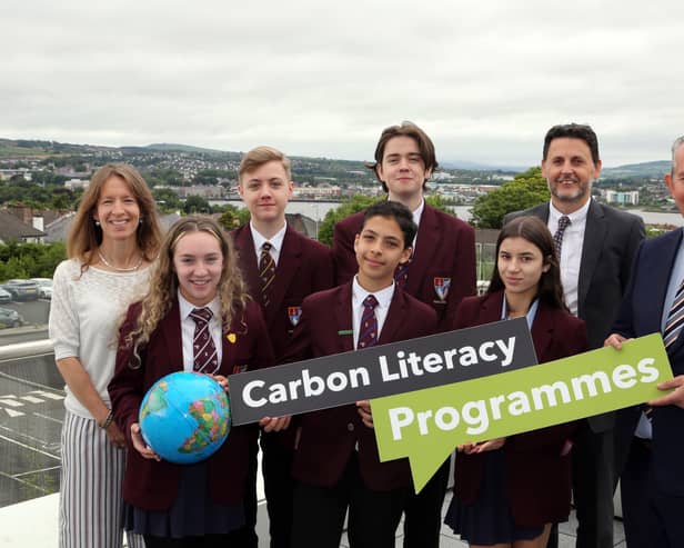 Pictured (l-r) are teacher Nicole Sloane, students Ellie Rankin, Andrew Logan, Anas Mohammad, James Daniell, and Farrah Foster with Scott Howes from Keep Northern Ireland Beautiful and Minister Poots.