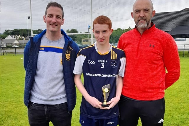 Conor O’Donnell of St. Columb’s College and Doire Trasna receives his ‘Player of the Tournament’ award from Steelstown Brian Ogs Chairman Paul O’Hea (left) and ‘A’ final referee, Gavin Hegarty.
