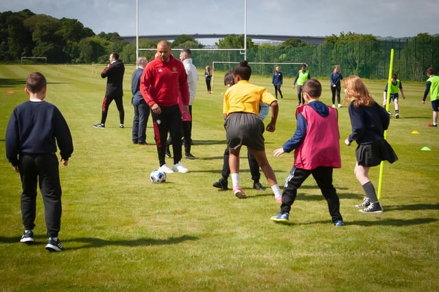 Former Manchester United star Wes Brown taking part in some soccer coaching with local primary schoolchildren during Friday's visit to Oakgrove Integrated College. Picture by Jim McCafferty Photography