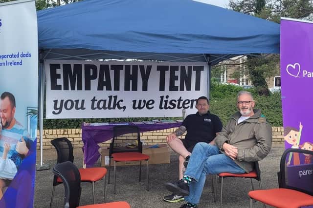 Oliver McLaughlin, a member of the Dads Project Steering Group with Cahir Murray, coordinator of the Dads Project in Parenting NI, at the Empathy Tent along the quay. The tent is there every day this week to provide support for dads and anyone else who needs it.