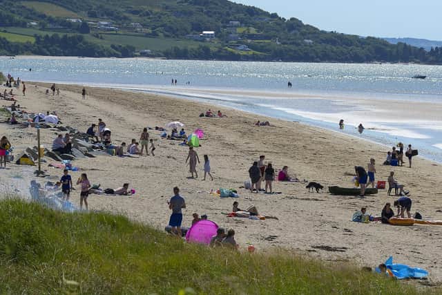 Sunbathers on Lisfannon beach during a heat spell in 2021. Photo: George Sweeney. DER2128GS – 048