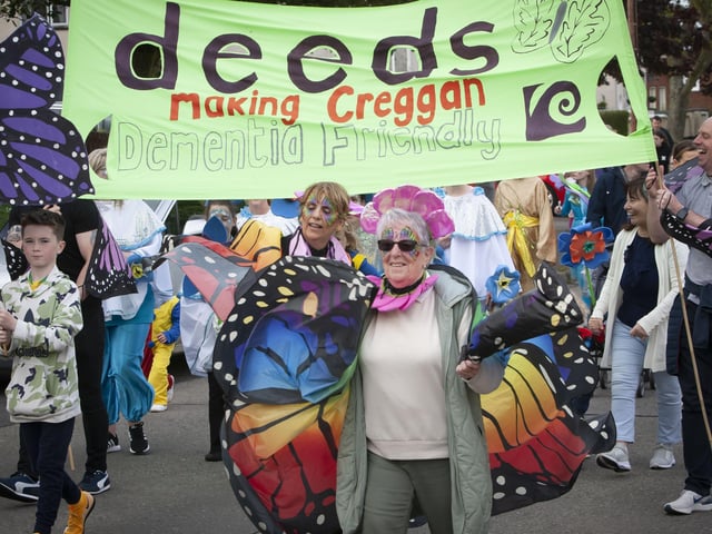 The OLT Deeds (Making Creggan Demential Friendly) banner is carried in Friday eveningâ€TMs parade.