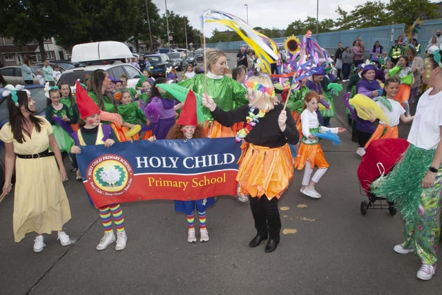 One of the colourful parade groupings - Holy Child PS, led by Principal Nicola Cullen and Vice Principal Pat Concannon on Friday evening.