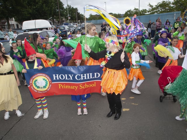 One of the colourful parade groupings - Holy Child PS, led by Principal Nicola Cullen and Vice Principal Pat Concannon on Friday evening.