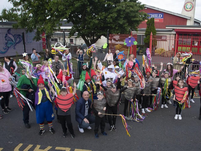 Pupils from Holy Child PS pose for a picture outside their school during Fridayâ€TMs Creggan Mid-Summer Carnival Parade.