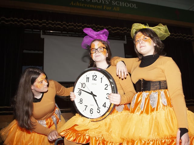 CHECKING THE TIME. . . .St. Ceciliaâ€TMs College girls Shannon Mooney, Cara-Leigh Doherty and Nicole Doran checking the time to go before the start of Fridayâ€TMs 75th Celebration Creggan Parade.