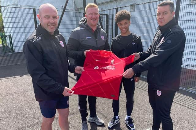 Derry City U17's coaching staff Shaun Holmes, Eugene Ferry and Gerald Boyle (manager) pictured with Liverpool bound Trent Kone-Doherty with the youngster's Liverpool shirt.