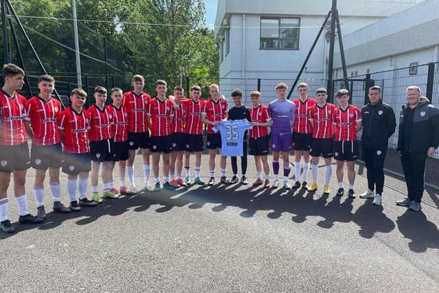 Trent Kone-Doherty pictured alongside his Derry City U17 team-mates and coaches as he receives a signed shirt from the club before making his switch to Liverpool.