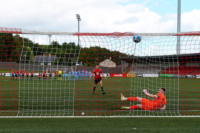 Maiden City’s Dylan McGavigan scores a goal during the penalty shootout against Institute. Picture by George Sweeney.