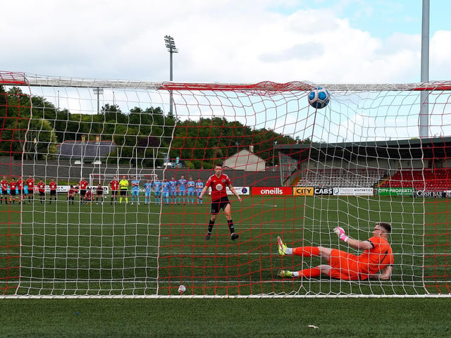 Maiden City’s Dylan McGavigan scores a goal during the penalty shootout against Institute. Picture by George Sweeney.