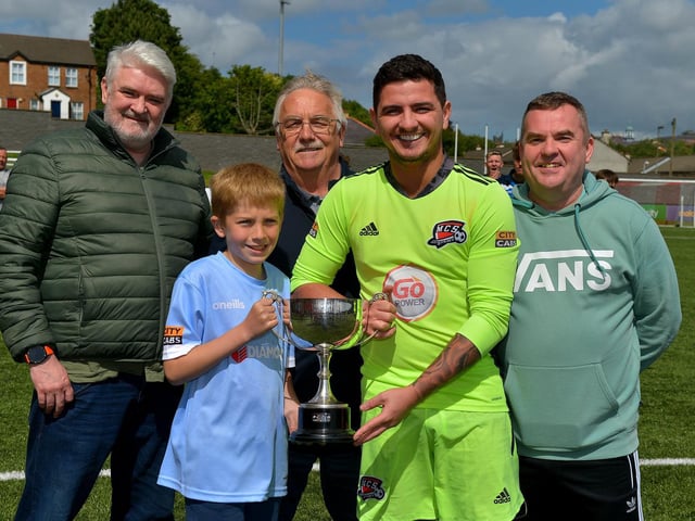 Maiden City captain Ray Kelly receives the Palmer/McDaid trophy from James Palmer after his side defeated Institute on penalties. Included in the photograph are Barry McDaid, on the left, Martin Palmer and Declan Palmer. Picture by George Sweeney.