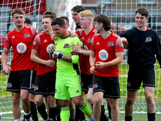 Maiden City players congratulate goalkeeper and captain Ray Kelly for his penalty shootout heroics against Institute. Picture by George Sweeney.