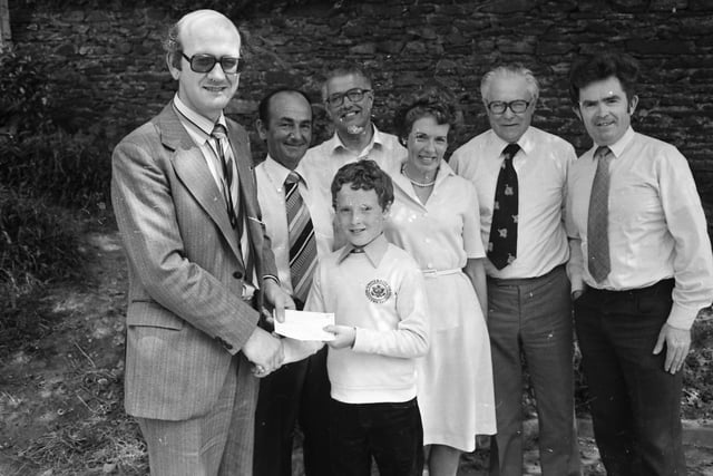 11-years-old Mark Woods, of St. Joseph’s N.S., Moville, overall winner of the essay competition ‘Water Pollution’, pictured receiving his surprise from Alan Kelly, Donegal County Council. Included, from left, are Nicholas Woods, Councillor Paddy Keaveney, Ann Woods, Arthur Spears and Seamus McTeague.