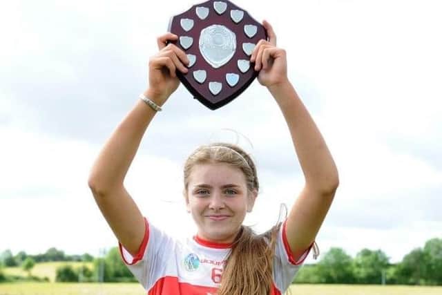 Derry captain Ellie McCartney lifts the Under 14 'A' Championship trophy after the young Oak Leafers defeated Antrim, Down and Armagh last weekend.