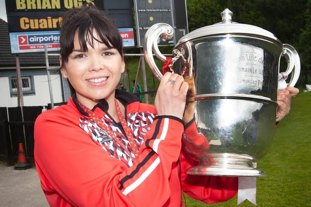 Steelstown PS Vice Principal, Ms. Catherine Doorish holding aloft the Ulster Intermediate Championship trophy won by Brian Og's Steelstown this year, during their visit to the club's grounds for the school's sports day on Thursday last. Picture by Jim McCafferty Photography