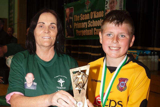 Seamus McShane St. John's receiving the Player of the Tournament award from Mrs. Breige O'Kane on Tuesday.