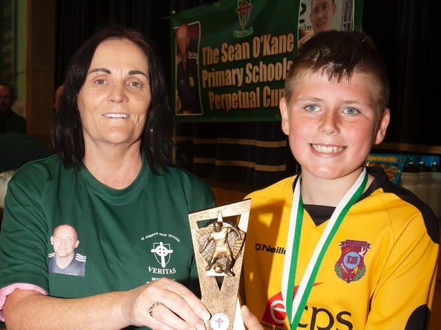 Seamus McShane St. John's receiving the Player of the Tournament award from Mrs. Breige O'Kane on Tuesday.