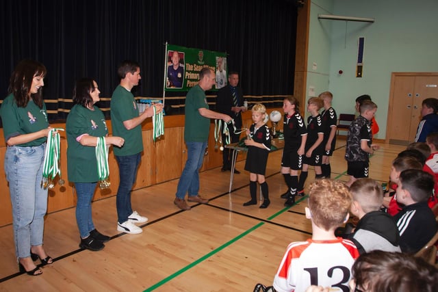 Members of the late Sean O'Kane's family present medals to the teams who took part in Tuesday's event.