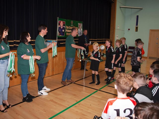 Members of the late Sean O'Kane's family present medals to the teams who took part in Tuesday's event.