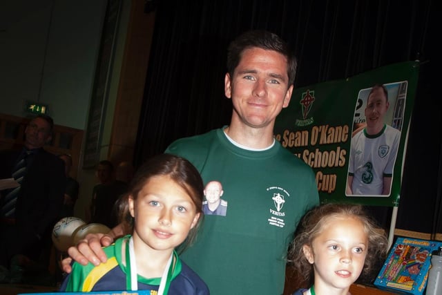 Kayla Starrs, Long Tower PS and Lauren Gallagher, Greenhaw PS - goalkeepers of the tournament pictured with Gareth McGlynn.