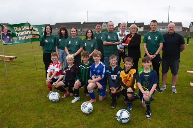 Family members of the late Sean O'Kane presenting the Sean O'Kane Primary Schools Perpetual Cup to Mrs. Martina McCarron, Principal at the school on Tuesday last.
